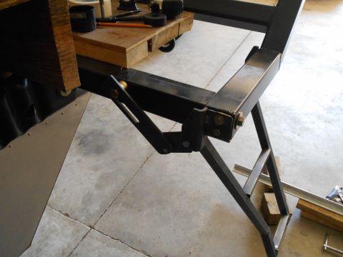 1992 Ford Bronco - A close-up view of a metal frame structure with a wooden block and tools resting on it.