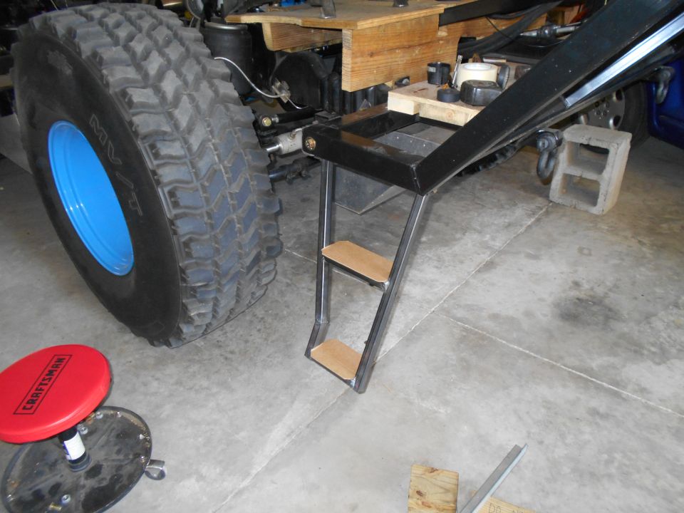Custom steps and large tire with blue rim
