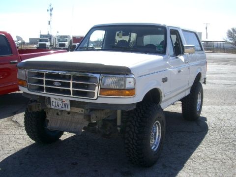 1994 Ford Bronco - This lifted 1994 Ford Bronco features oversized tires and a prominent grille, suggesting a off-road capability.
