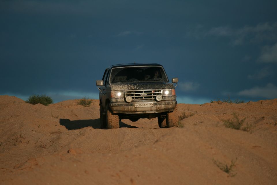 1987 Ford Bronco front view driving on sand dunes