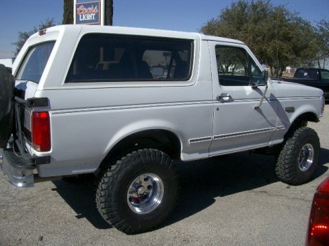 1994 Ford Bronco - This lifted Ford Bronco is shown from the side with a spare tire mounted on the rear.