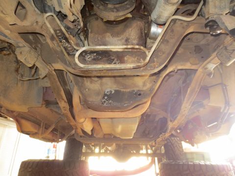 1996 Ford Bronco - The underside of a vehicle is visible, showing the drivetrain, exhaust, and suspension components.
