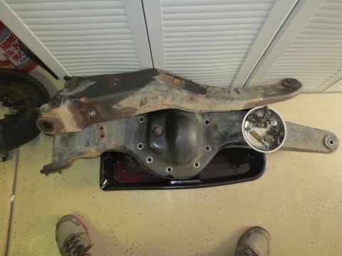1996 Ford Bronco - Rear axle assembly, likely from a 1996 Ford Bronco, with differential cover off and bolts collected.
