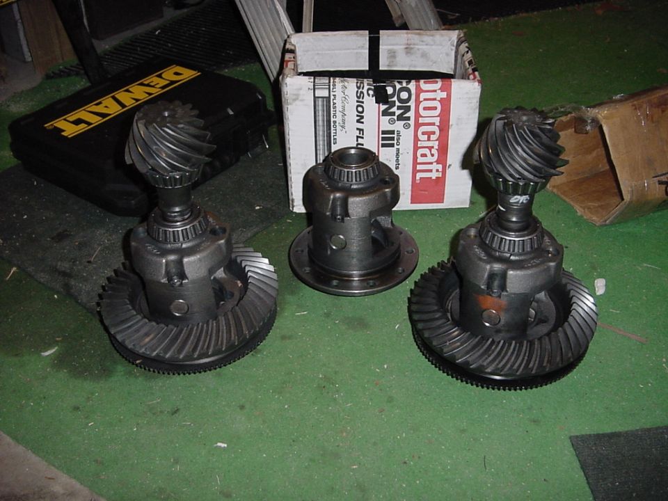 Three differential gears with pinions and ring gears. Motorcraft box in background