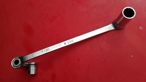 1965 Ford Mustang - A 7/8 inch socket wrench and a 12mm socket are shown on a red background.
