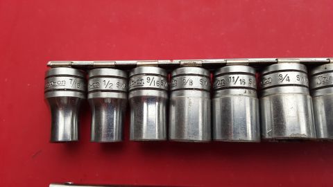 1965 Ford Mustang - A set of Snap-on sockets is displayed against a red surface, showing various fractional inch sizes.