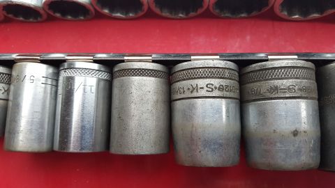 1965 Ford Mustang - A close-up view of a socket set, showing various sizes including 5/8, 11/16, 13/16, and 7/8 inches.