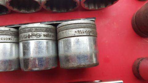 1965 Ford Mustang - A close-up view of a socket set, with visible engravings on the metal sockets.