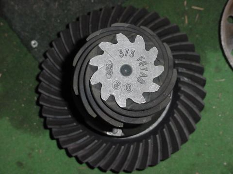 1989 Ford Bronco - A close-up view of a Ford differential gear set, showing the intricate teeth and stamped part numbers.