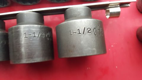 1965 Ford Mustang - A set of sockets, including 1-1/4 and 1-1/2 inch sizes, are displayed on a red background.