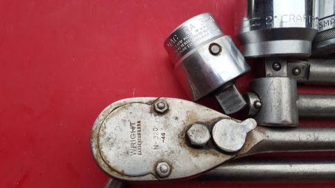 1965 Ford Mustang - A close-up shows a Wright socket wrench with a MAC socket attached, resting on a red surface.