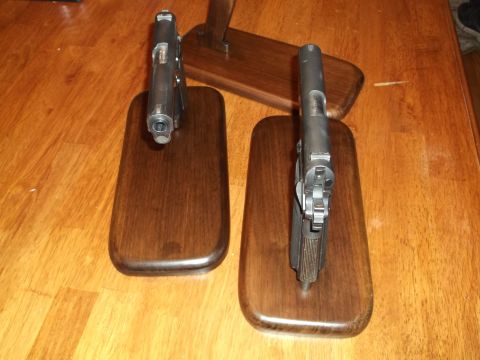 1995 Mercury Grand Marquis - Two handguns are displayed on wooden stands on a wooden table.