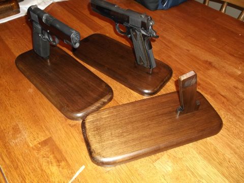1995 Mercury Grand Marquis - Two handguns are displayed on wooden stands on a table. The registry claims this is a 1995 Mercury Grand Marquis, but the image shows firea…