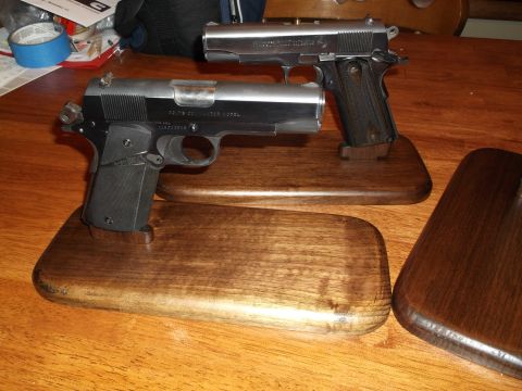 1995 Mercury Grand Marquis - Two handguns are displayed on wooden stands on a table.