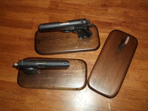 1995 Mercury Grand Marquis - Two handguns are mounted on separate wooden plaques, displayed on a wooden surface.