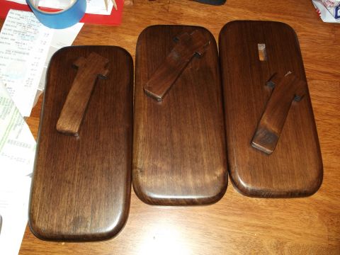 1995 Mercury Grand Marquis - Three wooden blocks with T-shaped wooden pieces are laid out on a table. Receipts are visible in the background.