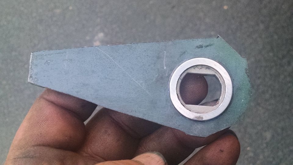 Metal part with hexagonal opening held by a hand