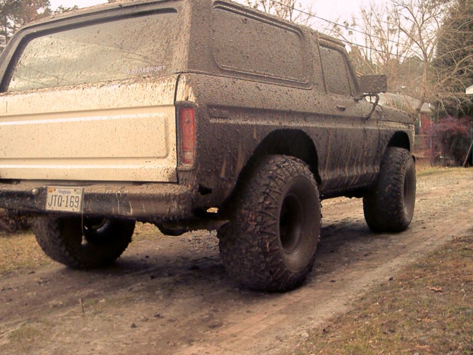 Mud-covered 1978 Ford Bronco rear view, showing license plate JTO-169