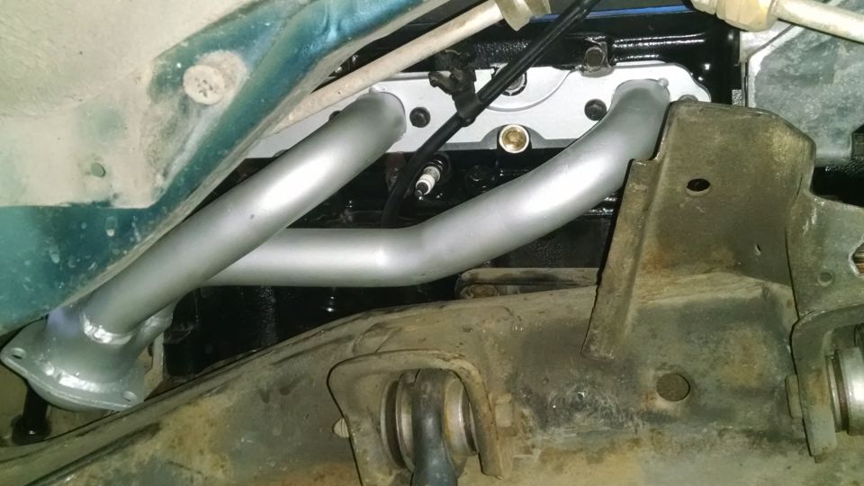 close-up of engine exhaust manifold and spark plug