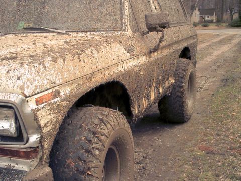1978 Ford Bronco - This SUV is heavily covered in mud, suggesting it has been off-roading.