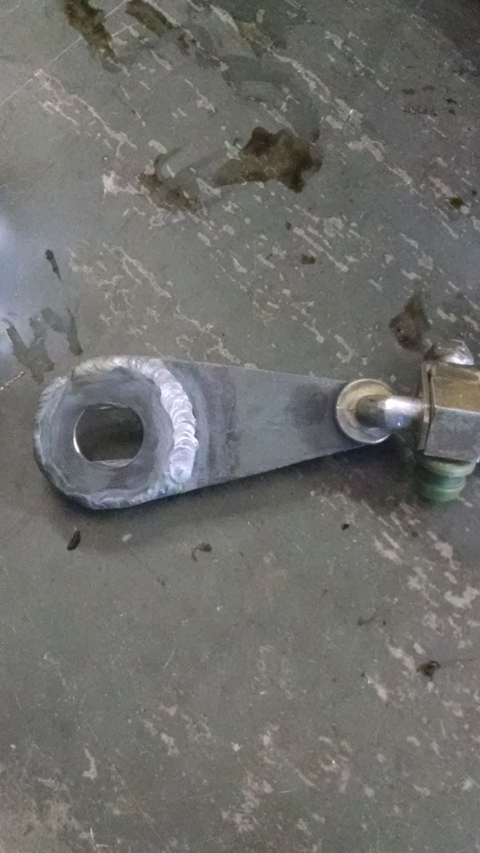 welded metal linkage with a hole on one end and a bolt on the other