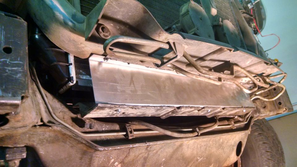 Undercarriage of a vehicle with exposed radiator and metal shielding