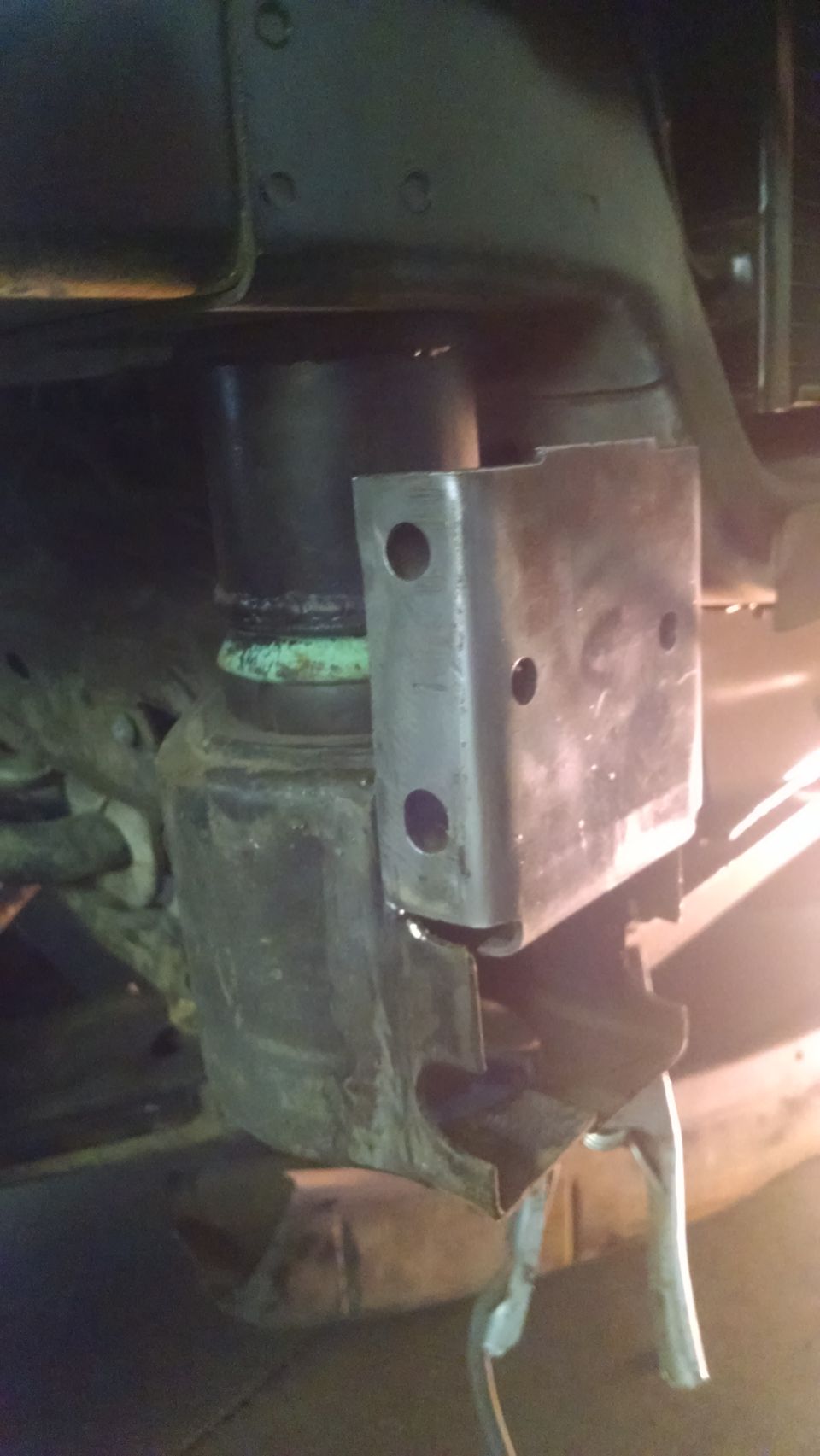 close-up of a metal bracket attached to a vehicle's suspension system