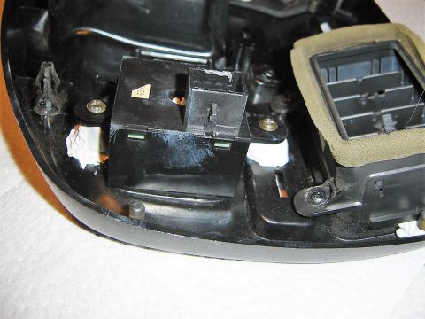 1996 Ford Bronco - Close-up view of a vehicle's interior dashboard showing a switch assembly and part of an air vent.