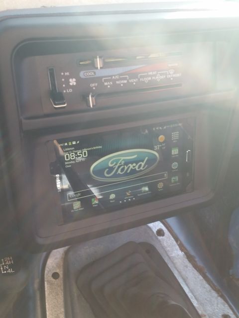 1988 Ford Bronco - The interior of a 1988 Ford Bronco features climate controls and a Ford-branded touchscreen display.