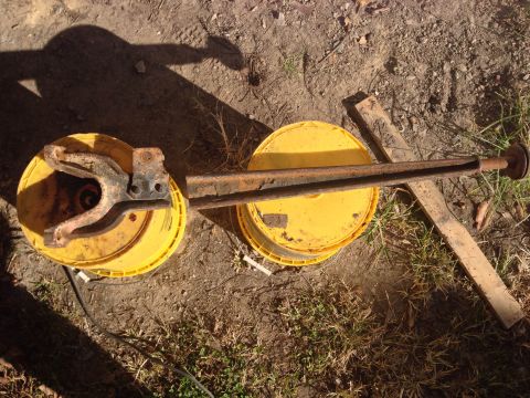 1979 Ford Bronco - Vehicle suspension components are shown resting on yellow buckets outdoors.