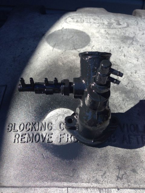 1979 Ford Bronco - A close-up of a brake master cylinder, possibly undergoing maintenance or repair.