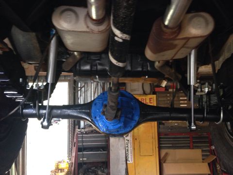 1979 Ford Bronco - The underside of a vehicle is shown, focusing on the rear axle and exhaust components.