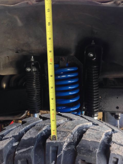 1979 Ford Bronco - Suspension components are measured next to a large off-road tire, with no visible year identification.