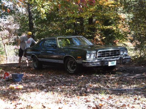 1979 Ford Ranchero - A dark green 1977 Ford Ranchero is parked in a wooded area, with a person standing next to it.
