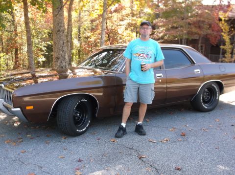 1979 Ford Ranchero - Man poses with his brown 1979 Ford Ranchero on a paved surface with trees in the background.