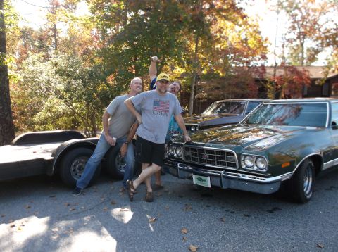1979 Ford Ranchero - Three men pose with a classic Ford Ranchero and a trailer, with autumn foliage in the background.