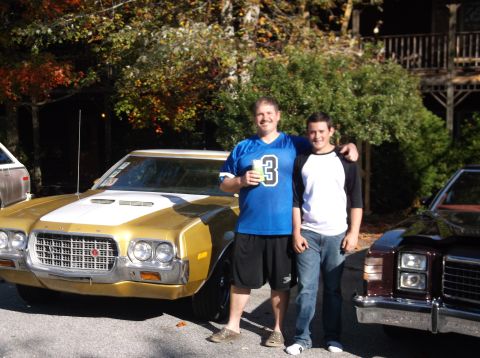 1979 Ford Ranchero - Two men stand next to a gold Ford Ranchero and a dark-colored vehicle.