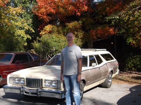 1979 Ford Ranchero - A man poses with a cream and brown station wagon, possibly a 1977 Mercury Grand Marquis wagon, in front of autumn foliage.