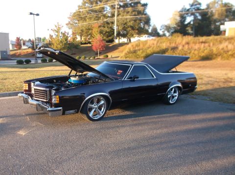1979 Ford Ranchero - Black 1979 Ford Ranchero parked outside with hood and trunk open, showing custom wheels.