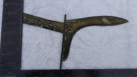 2007 Subaru Impreza - This ornate metal part, possibly a decorative element or weapon component, features a dragon motif and is shown with a ruler for scale.