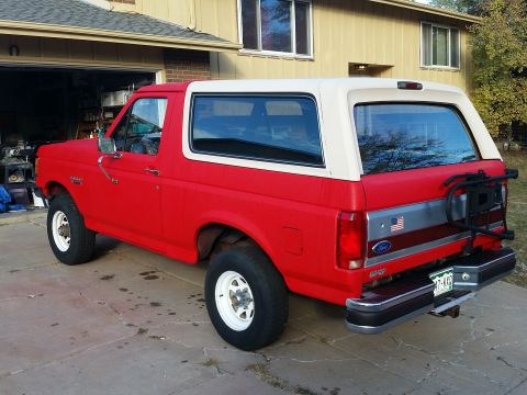 1988 Ford Bronco - This 1988 Ford Bronco is parked in front of a house with a two-tone paint scheme.