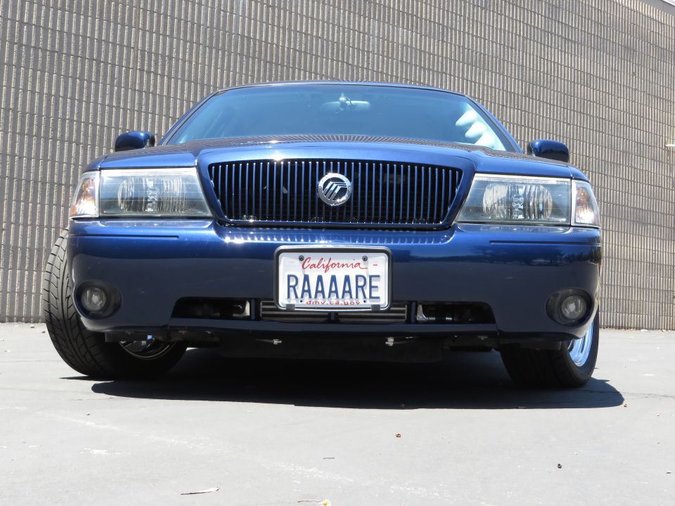 Front view of a blue Mercury Marauder with RAAAARE California plate