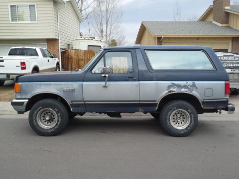 1988 Ford Bronco - This Ford Bronco has a two-tone paint scheme with some rust showing on the rear quarter panel.