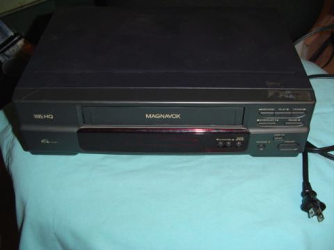 1999 Ford Taurus - A Magnavox VCR is shown from the front, with its control panel and tape slot visible.
