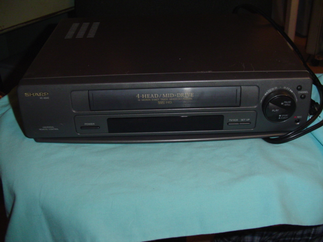 Sharp VCR with front panel controls and tape loading slot