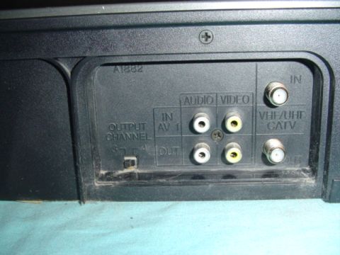 1999 Ford Taurus - Rear panel of a VCR shows audio, video, and coaxial inputs and outputs, along with channel selection.