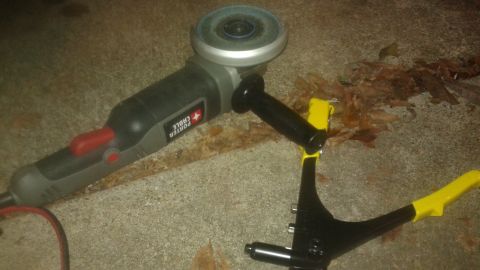 1996 Ford Bronco - Tools for repair work are laid out on a concrete surface next to some debris.