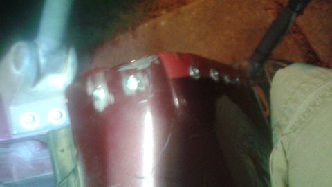 1996 Ford Bronco - The rear of a 1996 Ford Bronco shows damage to the tailgate and red trim.