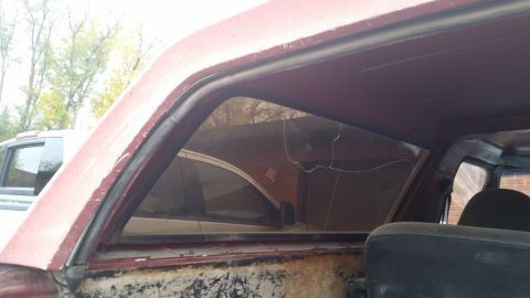 1981 Ford Bronco - The rear quarter window seal on this older SUV is visible, along with a crack in the glass.