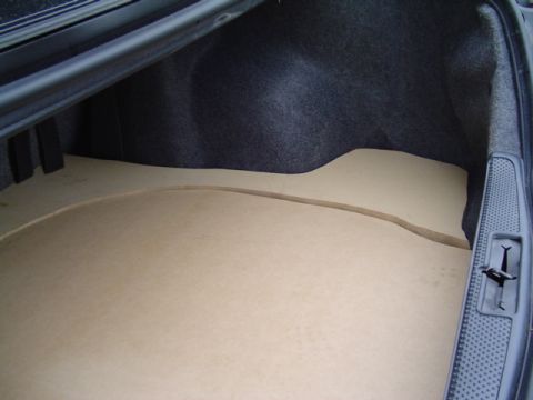1999 Ford Taurus - Close view down into a sedan trunk where two contoured MDF floor panels have been trimmed to follow the carpeted trunk pan and rear seat wa…